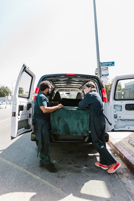 The image shows the rear side of a white commercial van parked on a street, partially blocking a shopfront with large windows and a glass door. Four blue heavy-duty rubbish bags are lined up on the pa